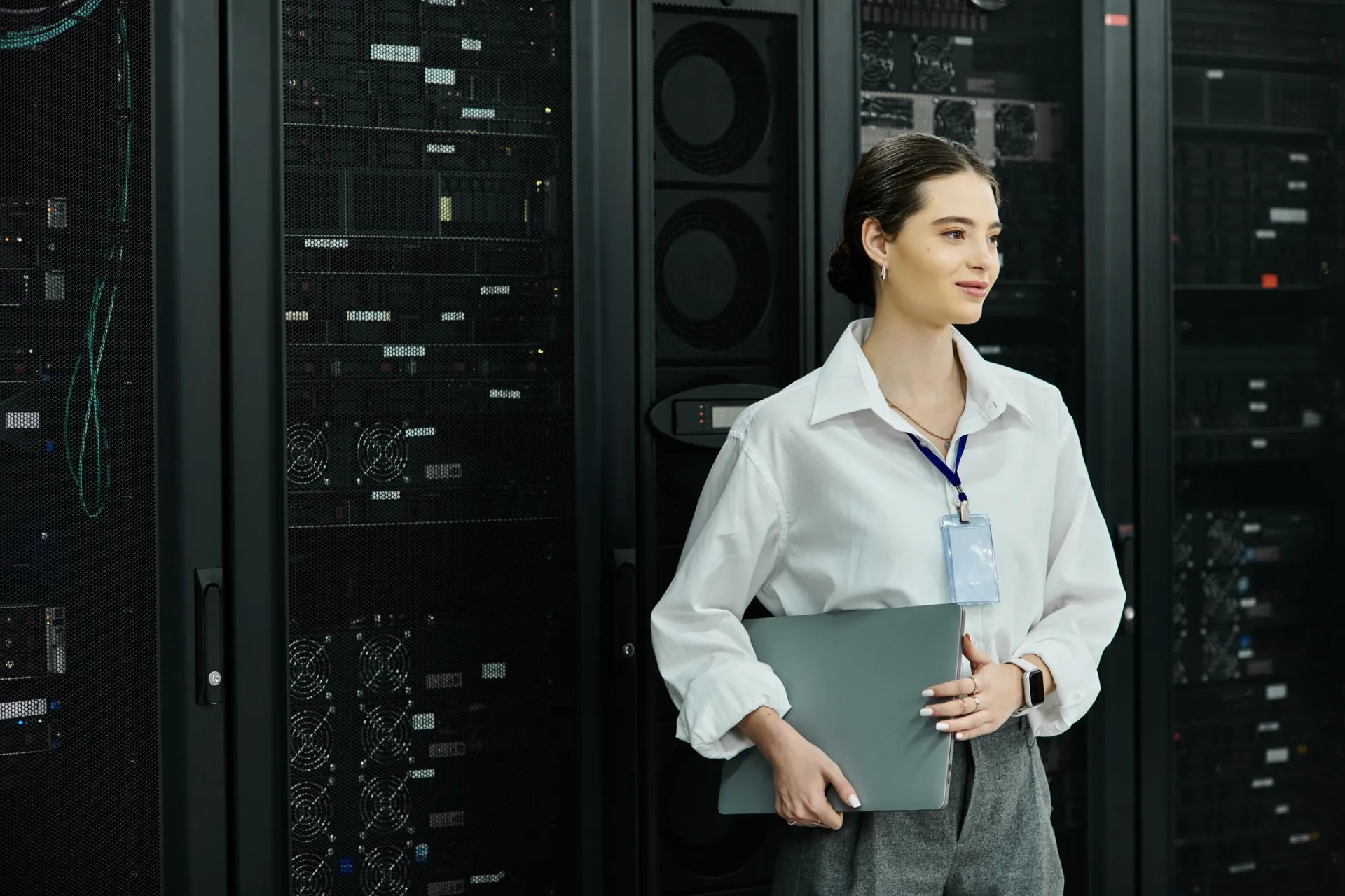 Technology decision-maker holding a laptop in a server room