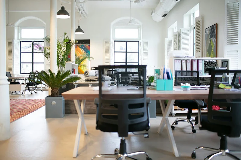 Bright modern office with desks and ergonomic chairs