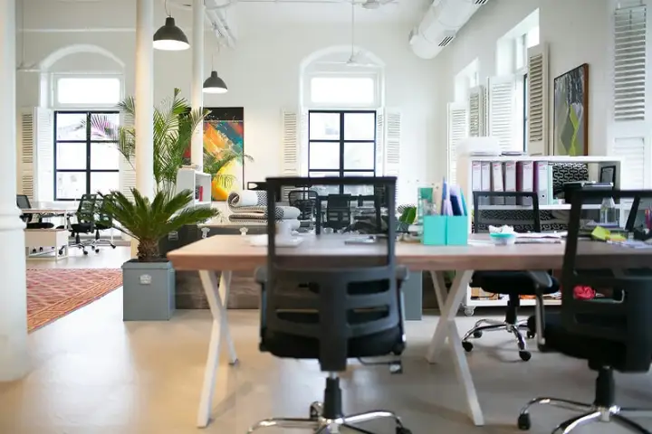 Bright modern office with desks and ergonomic chairs